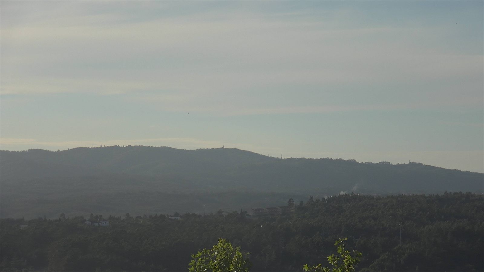 Camera frame: smoke over hills at dusk, marked by the AI