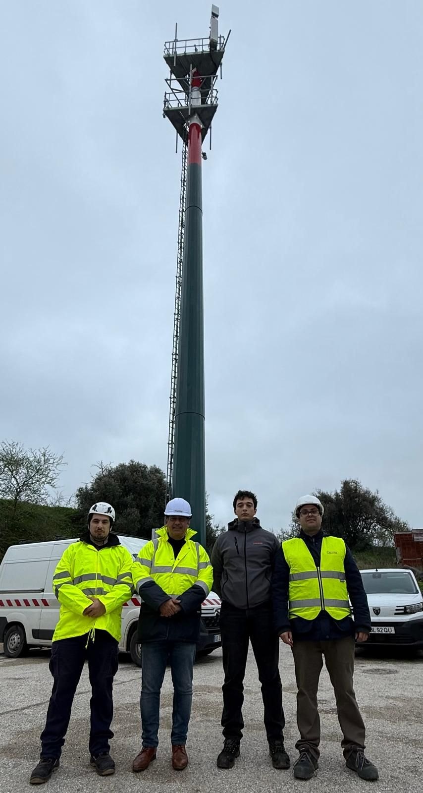 The LEITEK installation team in high-visibility vests at the foot of the Vodafone 5G tower in Lagos, with the SafeForest-DUO camera mounted at the top
